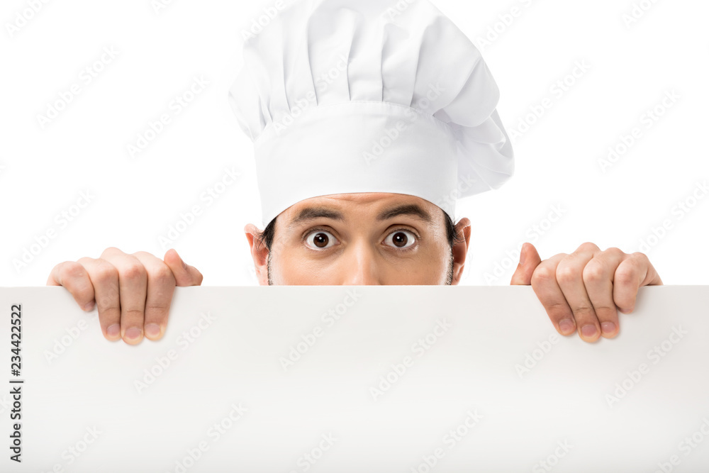 professional male cook peering out blank banner and looking at camera isolated on white professional male cook peering out blank banner and looking at camera isolated on white