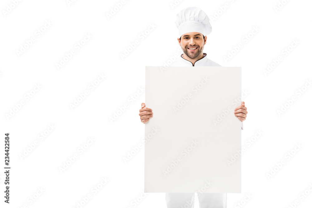 handsome young chef holding blank placard and smiling at camera isolated on white handsome young chef holding blank placard and smiling at camera isolated on white