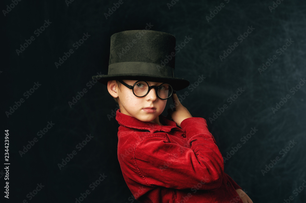 portrait of a boy close-up on a dark background . Child in red stylish shirt portrait of a boy close-up on a dark background . Child in red stylish shirt
