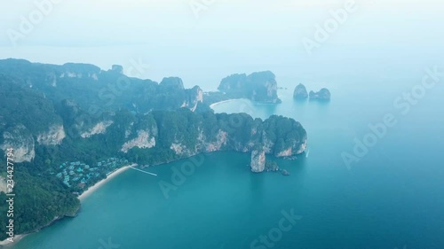 aerial footage drone flying over sea ocean coast harbor near cliffy mountains village rocky shore Thailand Krabi Ao Nang 4k video