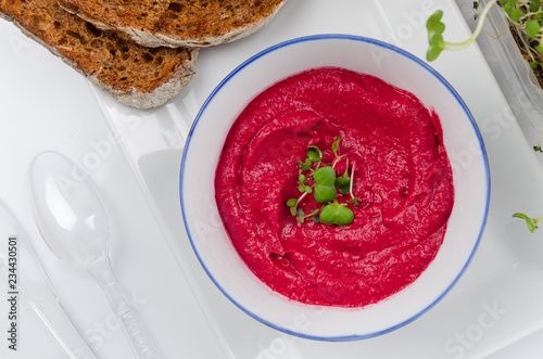 beet hummus in portions served with whole grain bread