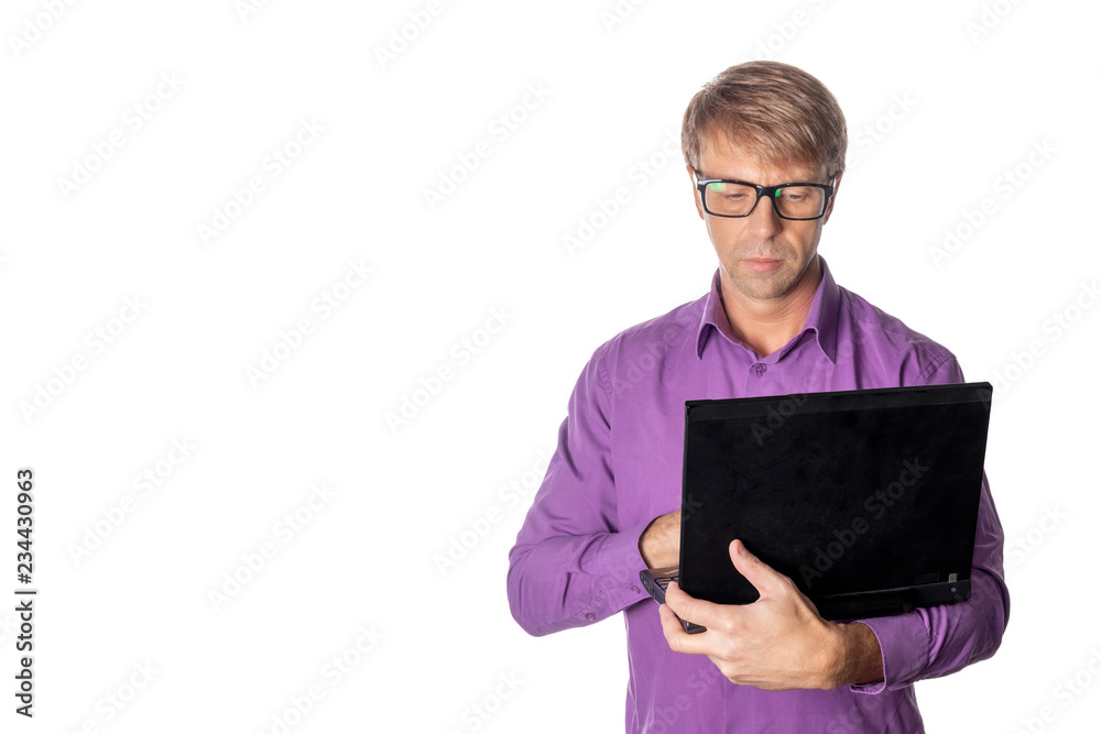 Portrait of handsome guy in casual shirt and glasses using laptop computer. Busy man working Portrait of handsome guy in casual shirt and glasses using laptop computer. Busy man working