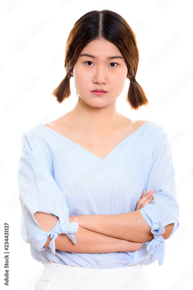 Studio shot of young beautiful Asian woman with arms crossed Studio shot of young beautiful Asian woman with arms crossed