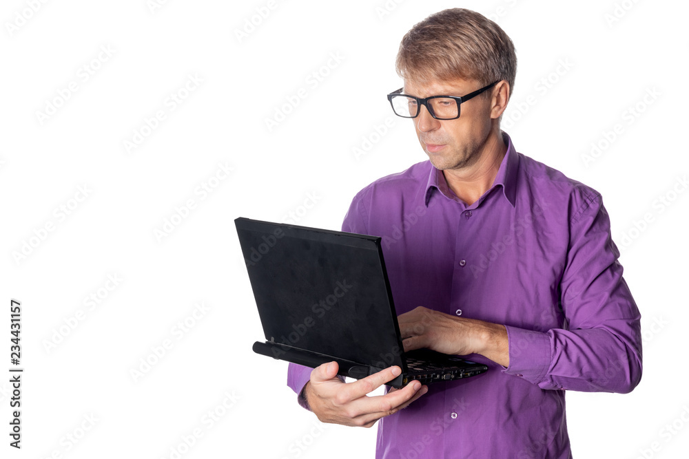 Portrait of handsome guy in casual shirt and glasses using laptop computer. Busy man working Portrait of handsome guy in casual shirt and glasses using laptop computer. Busy man working