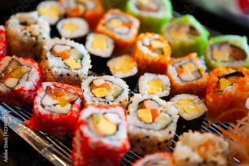 Assortment of tasty and delicious Sushi. Most popular Japanese food. Maki Sushi is vinegared rice filled with raw fish or seafood and wrapped in seaweed. Healthy eating and eat well concept.