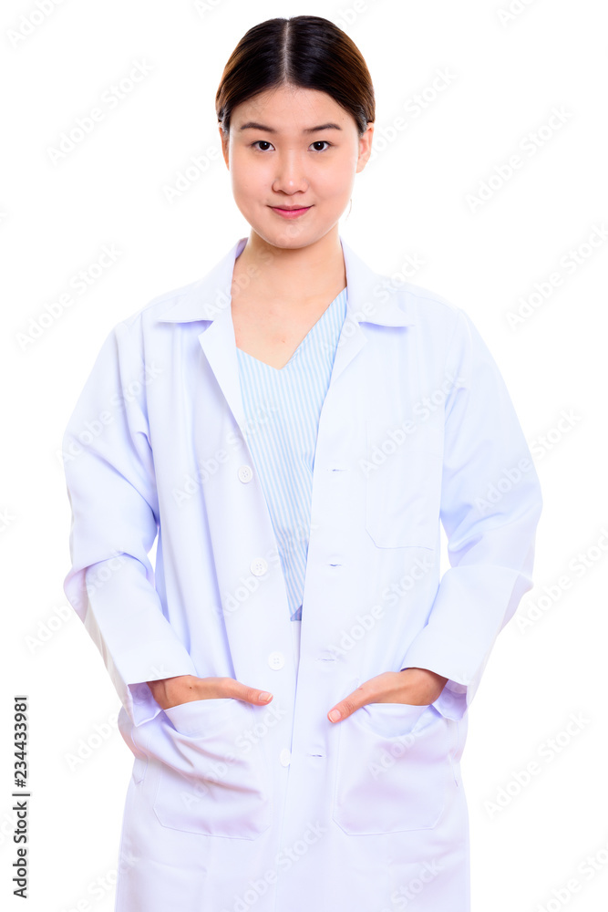 Studio shot of young beautiful Asian woman doctor standing with Studio shot of young beautiful Asian woman doctor standing with