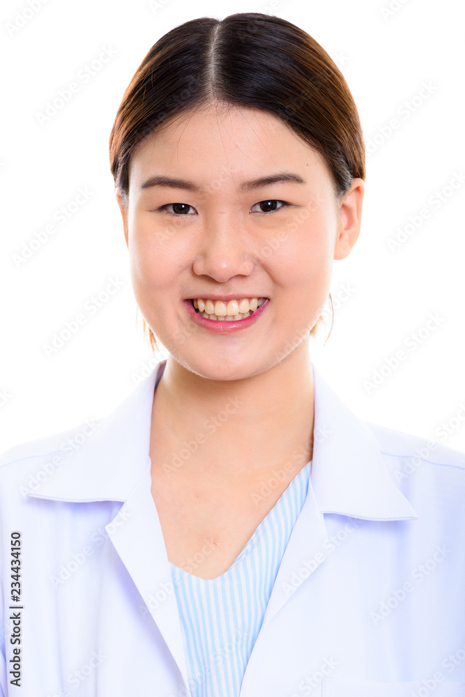 Face of young happy Asian woman doctor smiling