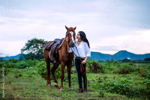 cowgirl  riding on a mountain with an yellow sky  Concept of friendly  and of summer vacation. © analysis121980