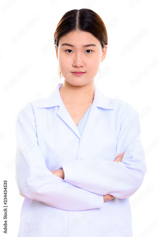 Studio shot of young beautiful Asian woman doctor with arms cros Studio shot of young beautiful Asian woman doctor with arms cros