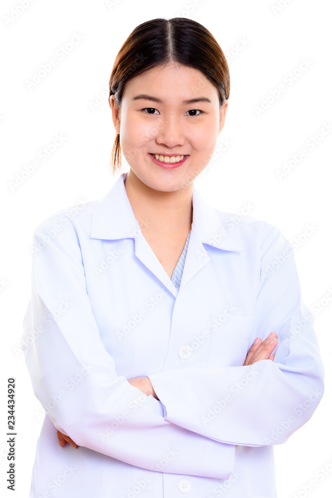 Young happy Asian woman doctor smiling with arms crossed Young happy Asian woman doctor smiling with arms crossed