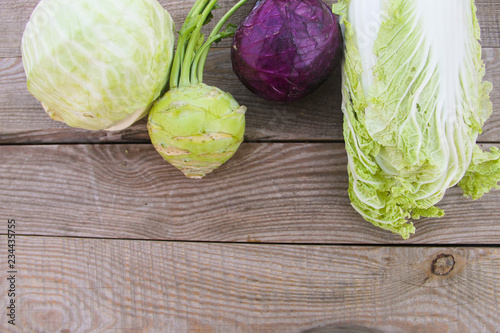 Set of different type of cabbage on rustic wooden table