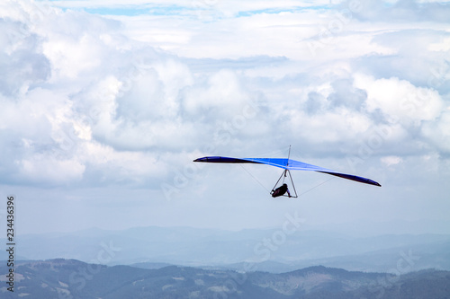 Light aircraft, deltaplane, against the sky with white clouds. deltaplane