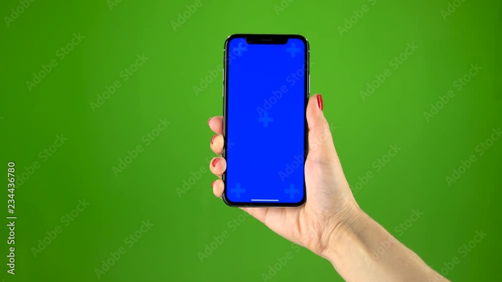 Holding hand a mobile smartphone blue screen. Green screen