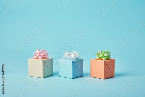 Different gifts with bows on blue background photo