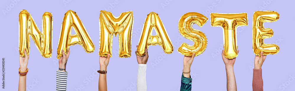 Hands holding Namaste word in balloon letters Hands holding Namaste word in balloon letters