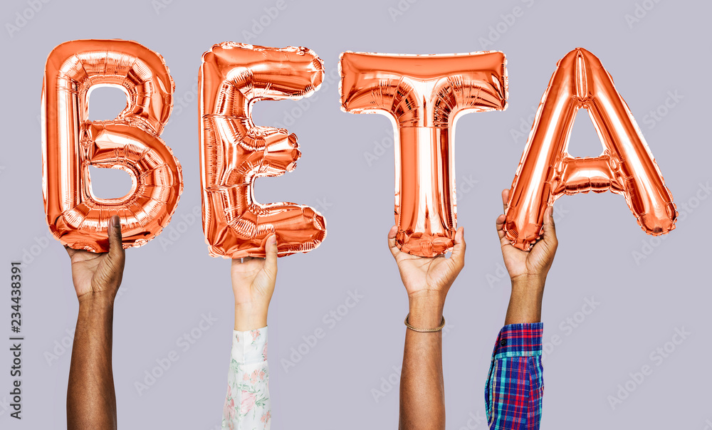 Hands holding beta word in balloon letters