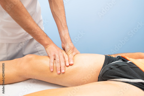 Quadriceps massage to an athlete by a physiotherapist