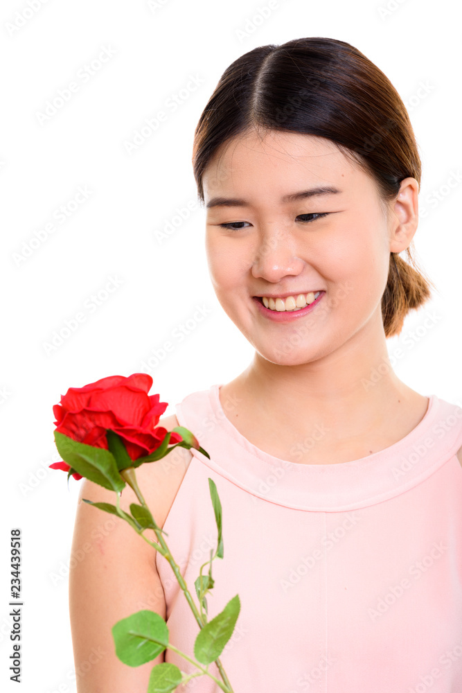 Close up of young happy Asian woman smiling while holding and lo Close up of young happy Asian woman smiling while holding and lo
