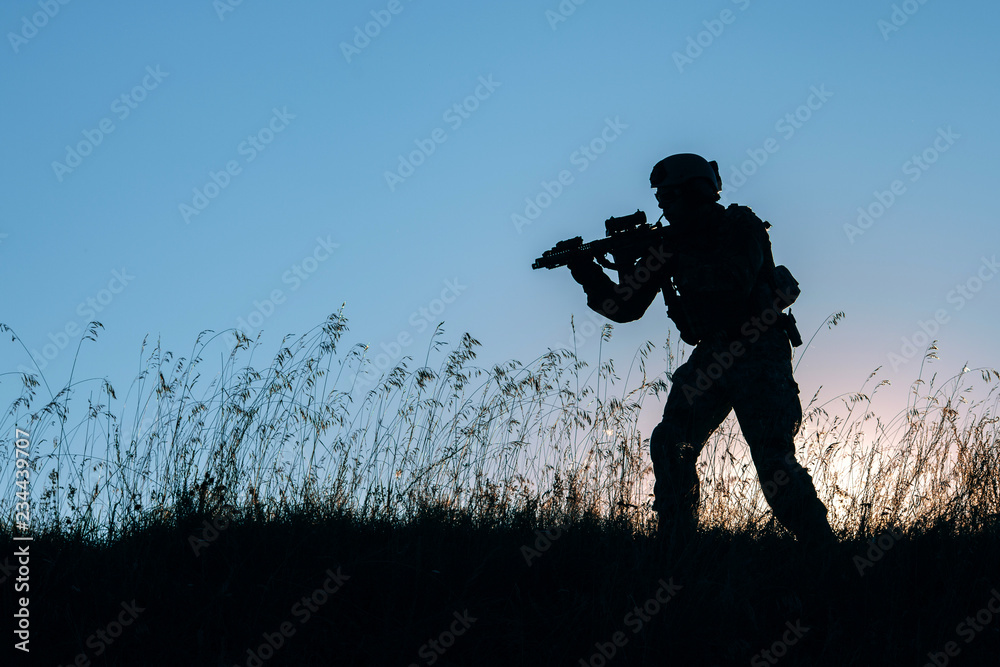 military soldier with weapons at sunset. shot, holding gun, colorful sky. military concept. military soldier with weapons at sunset. shot, holding gun, colorful sky. military concept.