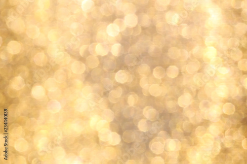 Christmas abstract gold bokeh background with light color in blur.