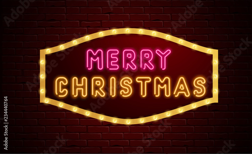 Merry Christmas neon luminous sign on brick textured background.