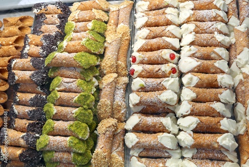 showcase of pastry with Sicilian cannoli made with ricotta pista photo