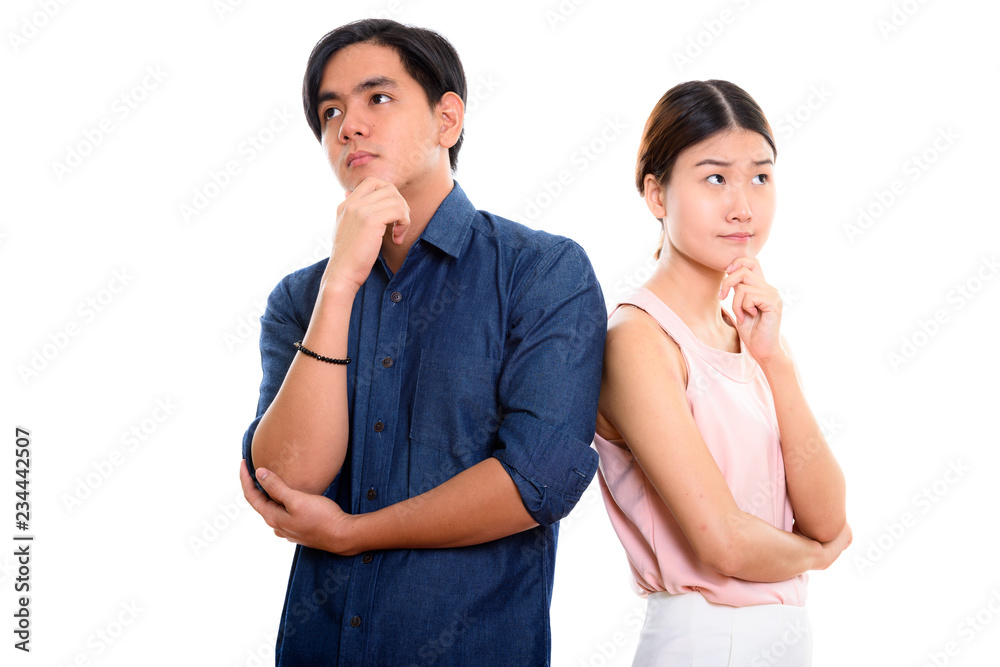Young Asian couple thinking and looking up Young Asian couple thinking and looking up