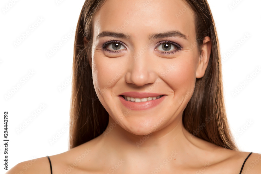 Portrait of young beautiful smiling girl on white background Portrait of young beautiful smiling girl on white background
