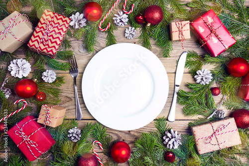Festive table setting with cutlery and Christmas decorations on wooden table. Top view.