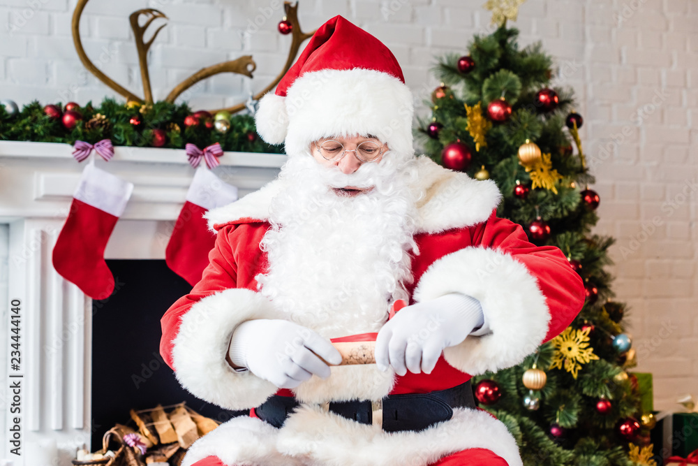 santa claus holding rolled parchment with wish list santa claus holding rolled parchment with wish list