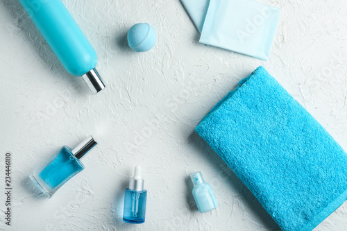 Composition with clean soft towel and toiletries on white background
