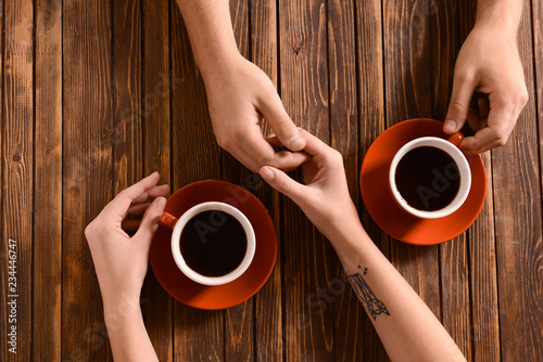 Young couple with cups of c...