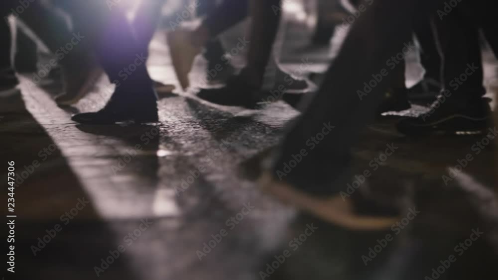 People on crosswalk in busy city street at night slomo