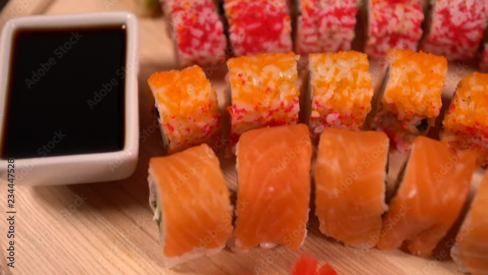 Sushi rolls and soy sauce on a wooden board Sushi rolls and soy sauce on a wooden board