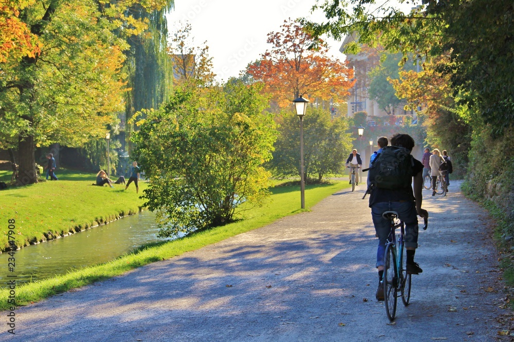 Obraz premium A man riding the bike to the office to start a working day instead of taking car or subway. Concept of healthy lifestyle. Environmentally friendly commute to university or school. Men unidentifiable