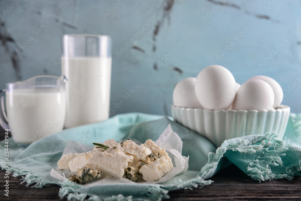 Tasty cheese and bowl with eggs on table Tasty cheese and bowl with eggs on table