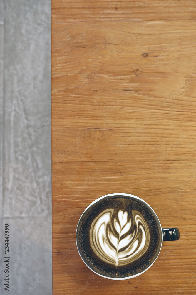 Fototapeta premium a cup of latte art coffee on wooden background