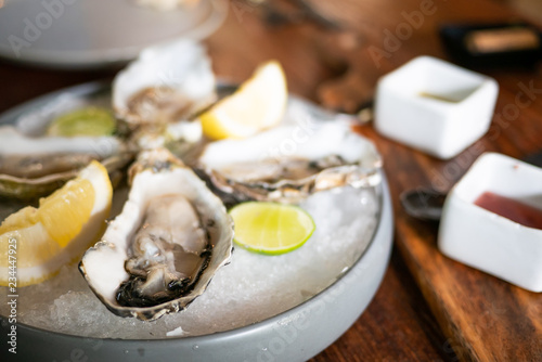 Tasty fresh oysters close-up on ice. Raw oysters are packed with nutrition, high in calcium, potassium, magnesium, vitamin and mineral. Flavor are sweet and refreshing. Believed to be an aphrodisiac.