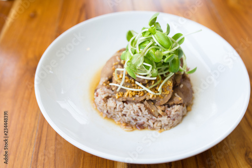 Garlic chashu pork with brown rice ,topping with sunflower sprouts.