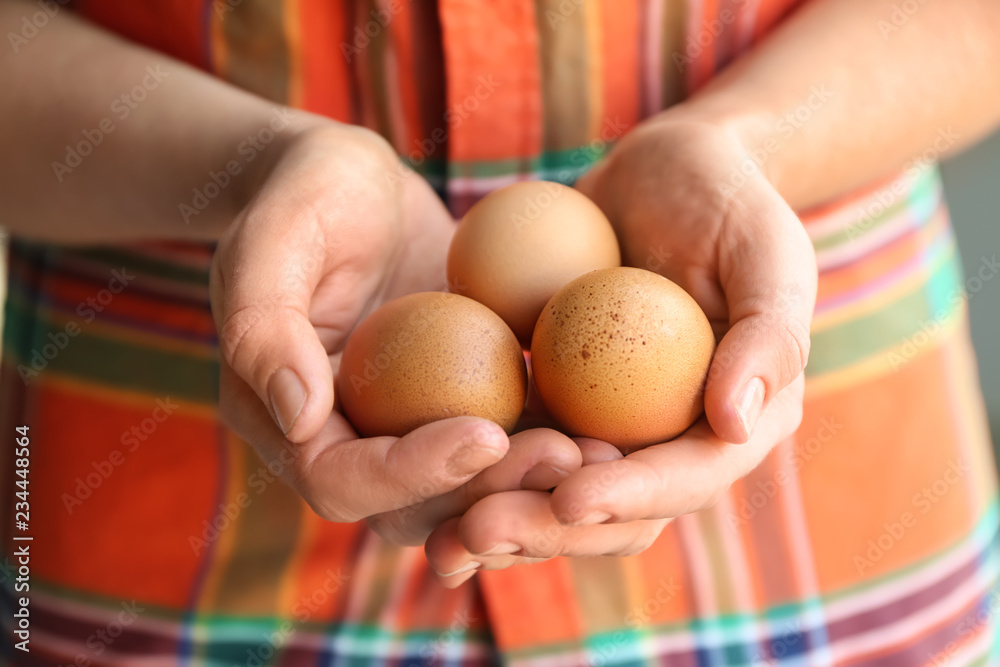 Woman holding brown chicken eggs, closeup Woman holding brown chicken eggs, closeup