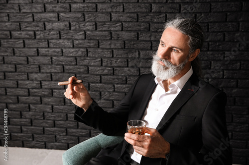 Senior man drinking whiskey...