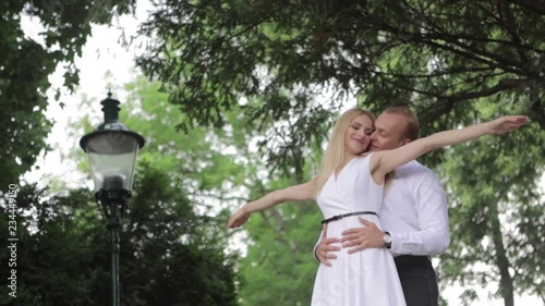 Young couple walking in the park. The have fun and rejoice. Black and white clothes