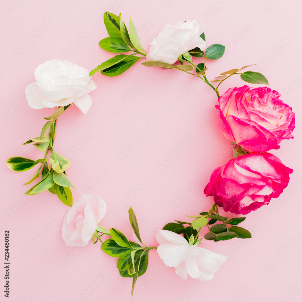 Wreath floral frame with white and red roses flower and leaves on pink background. Flat lay, top view. Wreath floral frame with white and red roses flower and leaves on pink background. Flat lay, top view.