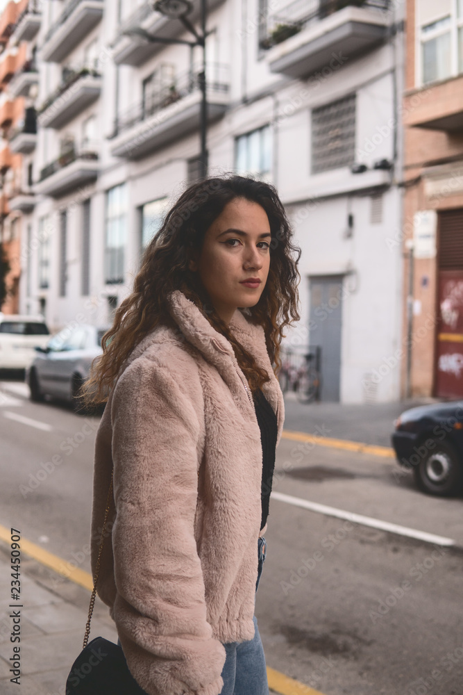 Stylish female standing on city street Stylish female standing on city street