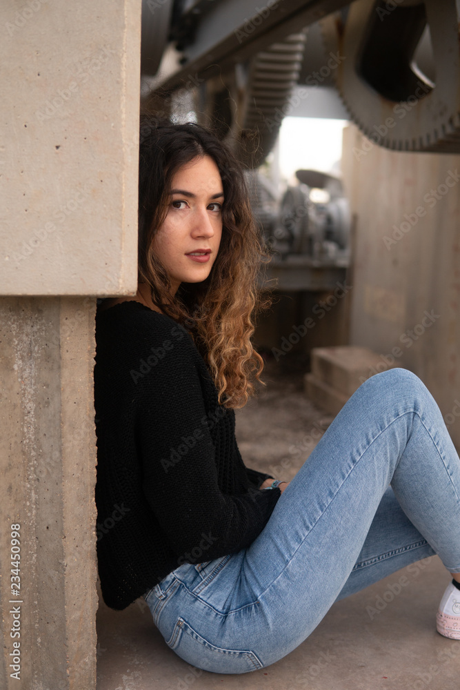 Pretty woman leaning on building wall Pretty woman leaning on building wall