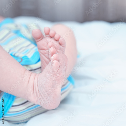 The tiny feet of the newborn . The concept of motherhood and child protection. Close-up. Copy space