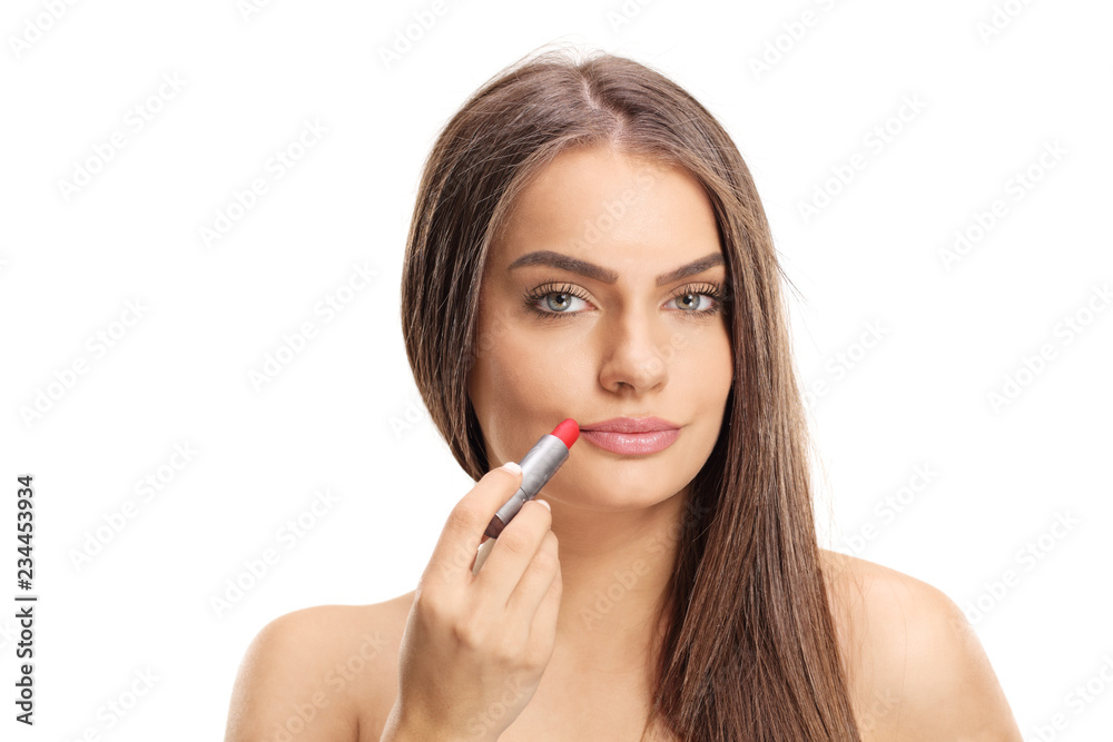 Attractive young woman applying red lipstick Attractive young woman applying red lipstick