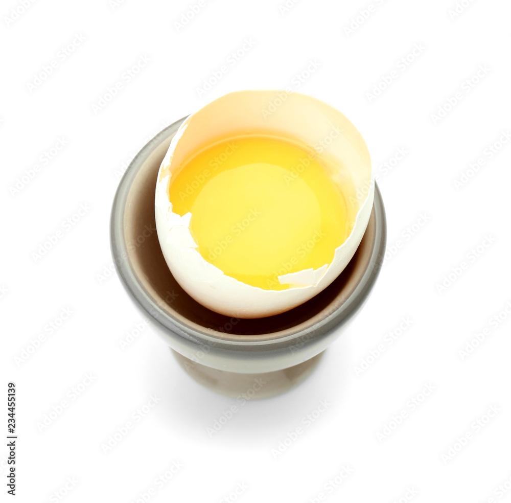 Raw chicken egg in holder on white background Raw chicken egg in holder on white background