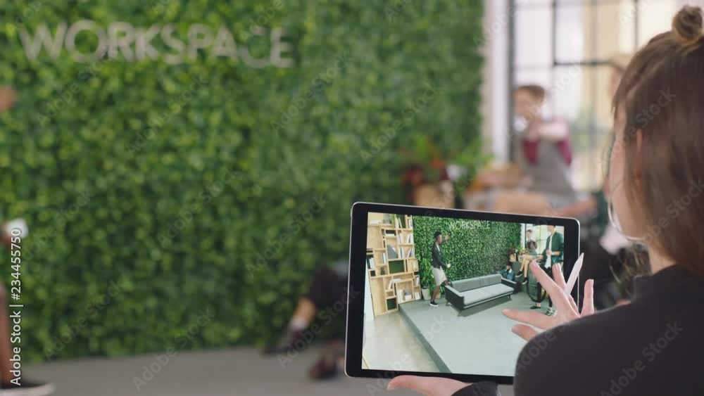 young caucasian woman engineer using digital tablet computer testing virtual reality software planning office layout on screen diverse team enjoying modern workplace teamwork