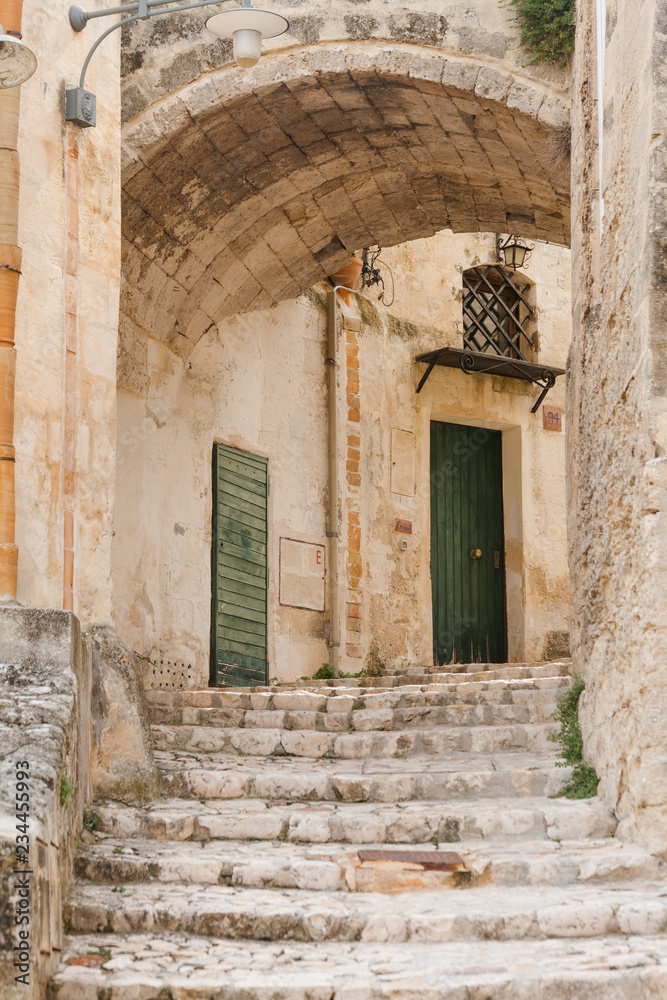 Ancient town of Matera (Sassi di Matera), European Capital of Culture 2019, Basilicata, Southern Italy. Narrow street Ancient town of Matera (Sassi di Matera), European Capital of Culture 2019, Basilicata, Southern Italy. Narrow street